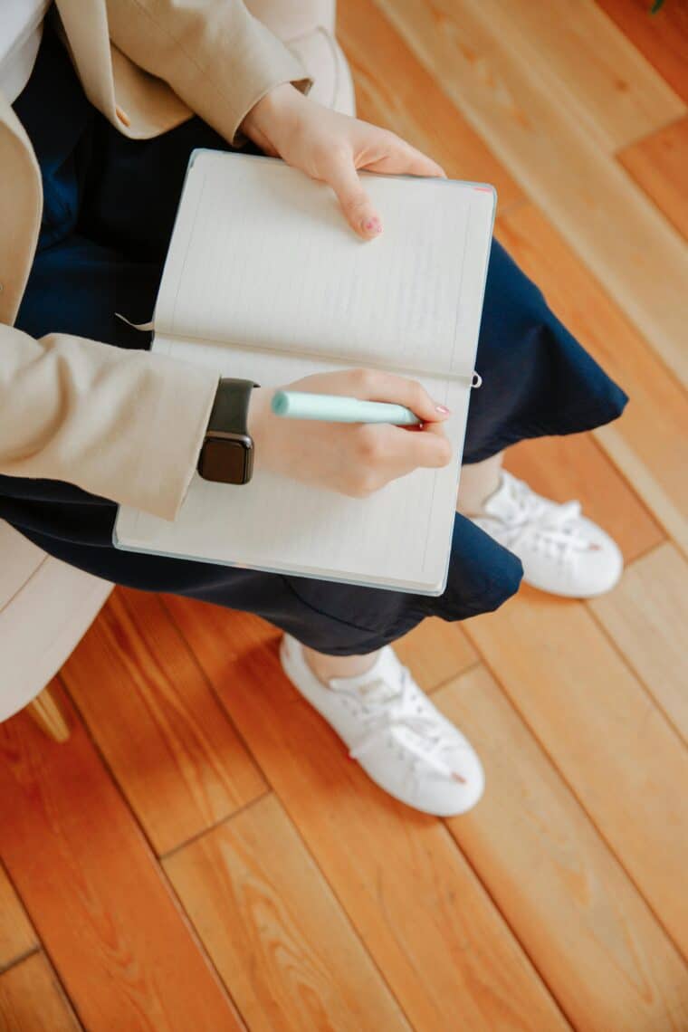 person writing in notebook