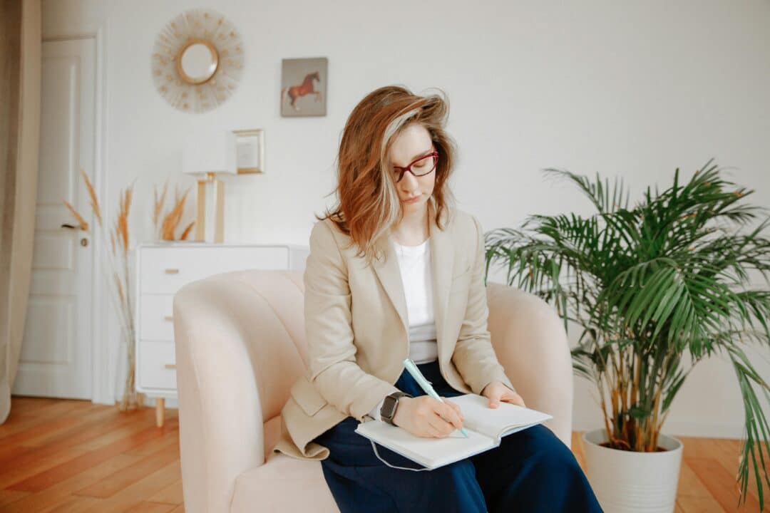 therapist writing in notebook